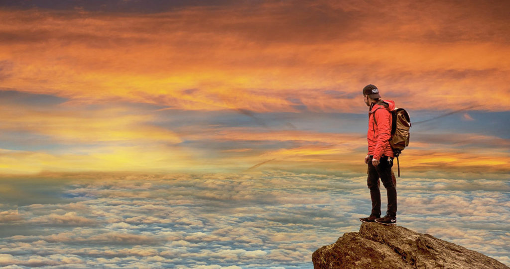 hiker-rock-mountaintop-1920-e1553236941890-1024x541